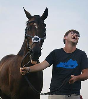 Zachary Chaney laughing as a horse sticks out its tongue. Zachary Chaney laughing as a horse sticks out its tongue.